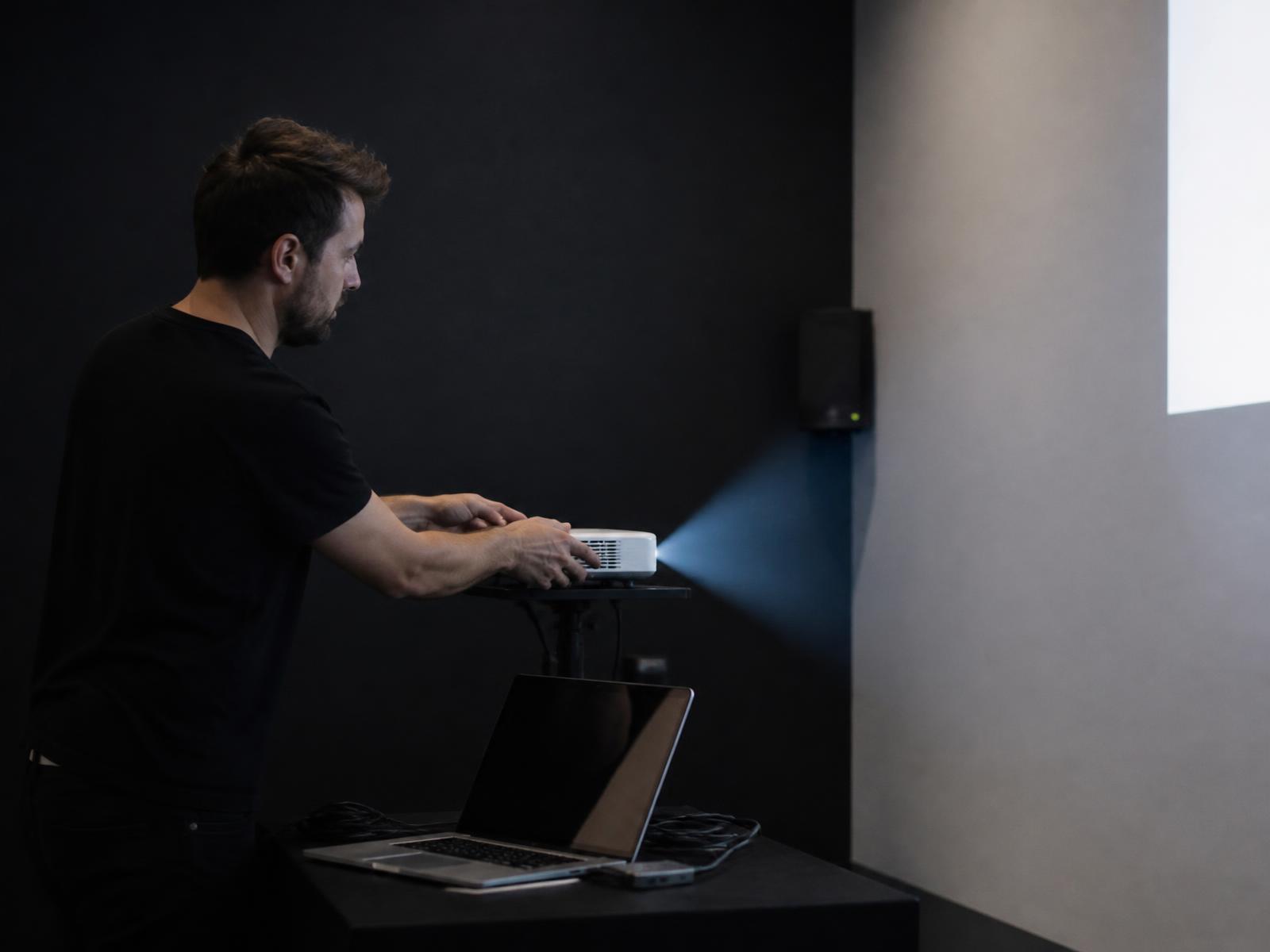 Membre de l'équipe Outvision qui installe le dispositif Play'In Village dans une salle