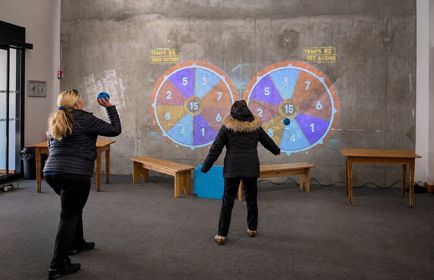 Animation Play'In Village : des familles et des enfants jouent ensemble sur un grand jeu interactif projeté dans une salle d'événement